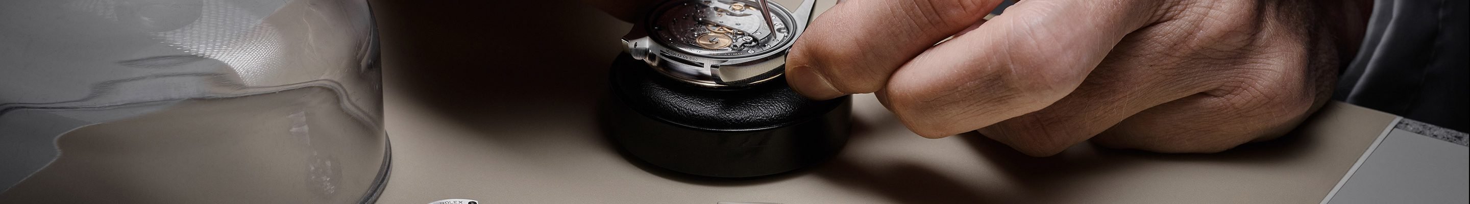 Detail of a Rolex watch being serviced by a watchmaker
